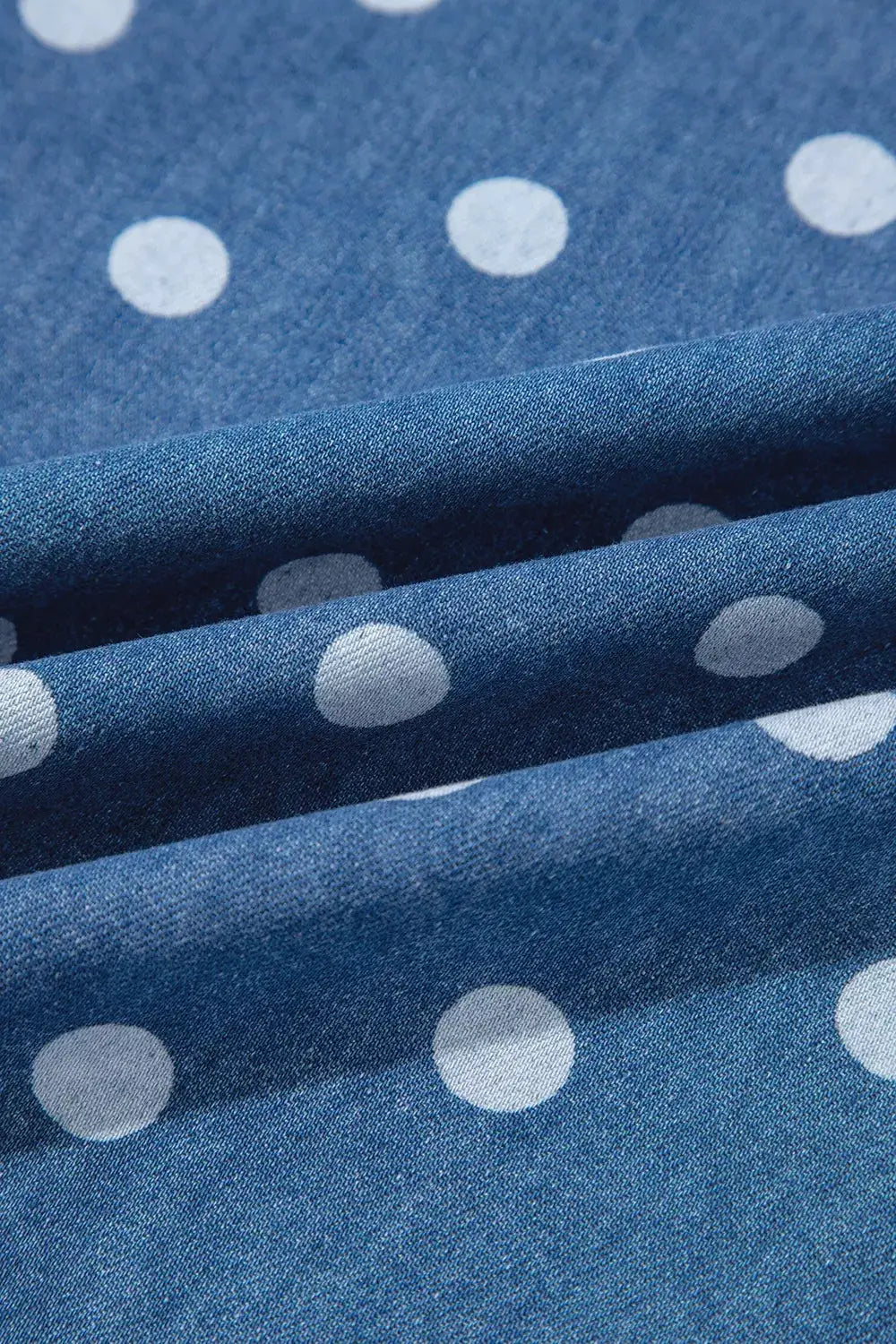 Polka dot long-sleeve tunic jacket fabric in blue with white dots; close-up denim-like texture