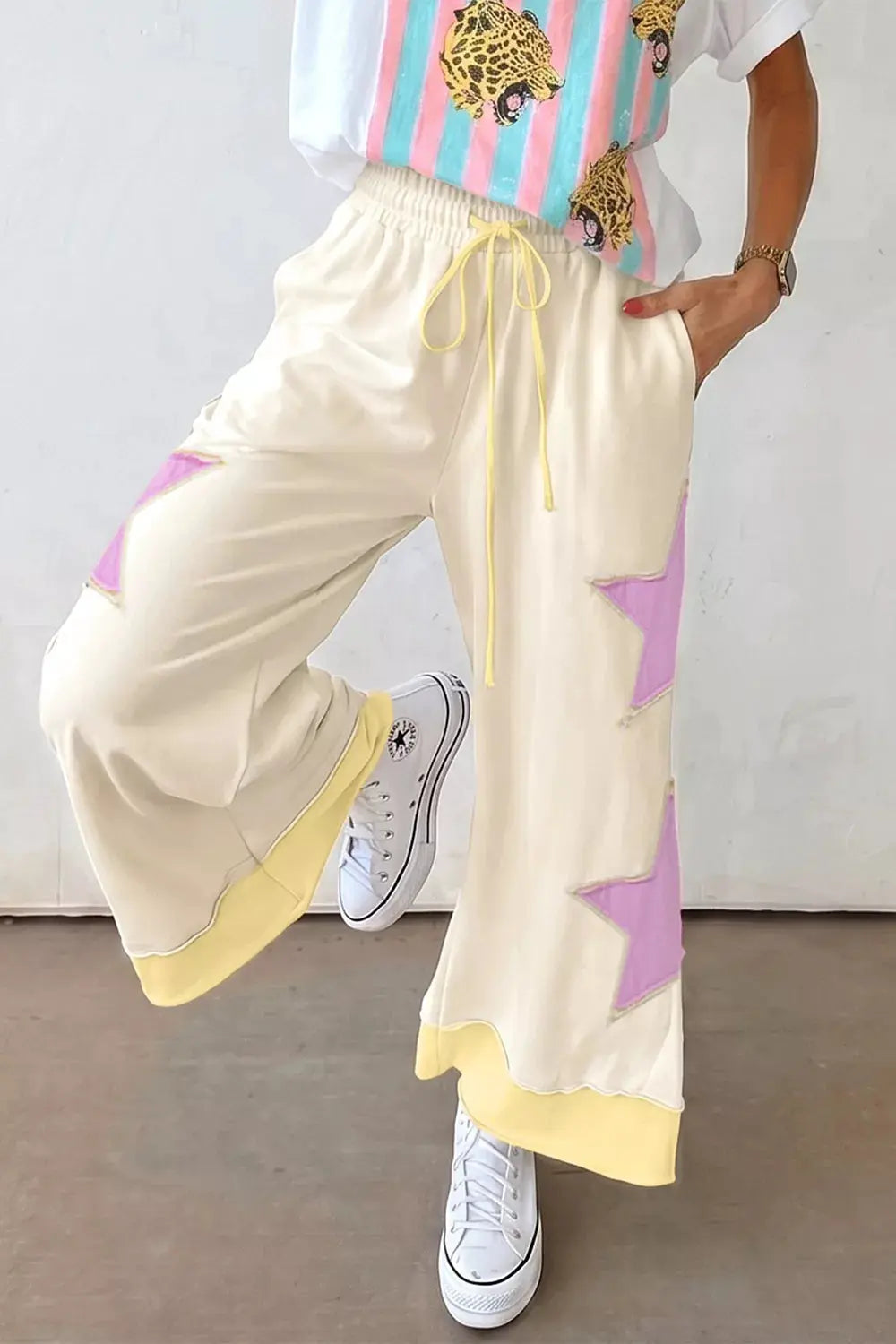 Star Patch Wide Leg Pants, cream with pastel pink/purple star patches and a yellow drawstring waist