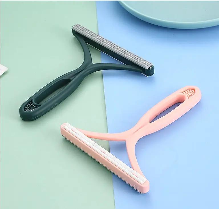 AdTec silicone double-sided pet hair remover pair; dark green and pink handheld lint shavers for fabric and clothes.