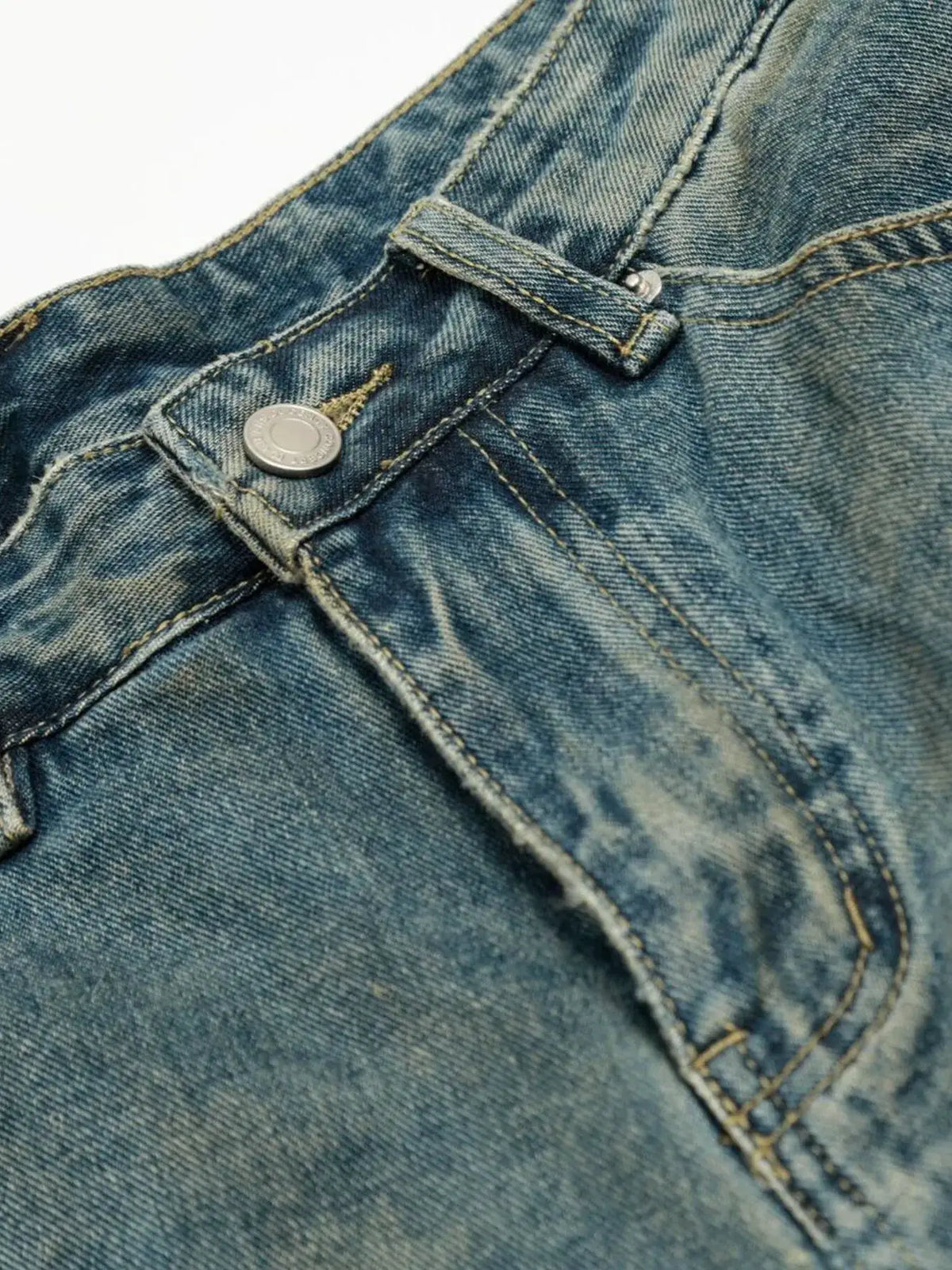Men's distressed denim shorts close-up of pocket with rivet and belt loop in blue wash