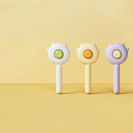 Cat paw massage brush set; three pastel handles with paw-shaped heads in white, yellow, lavender.