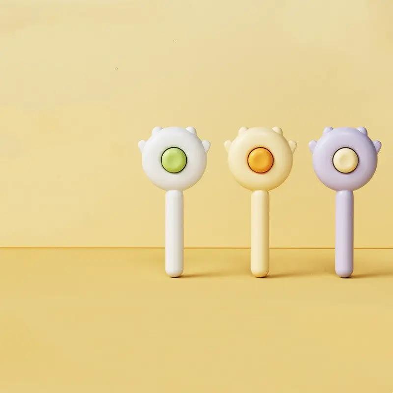 Cat paw massage brush set; three pastel handles with paw-shaped heads in white, yellow, lavender.