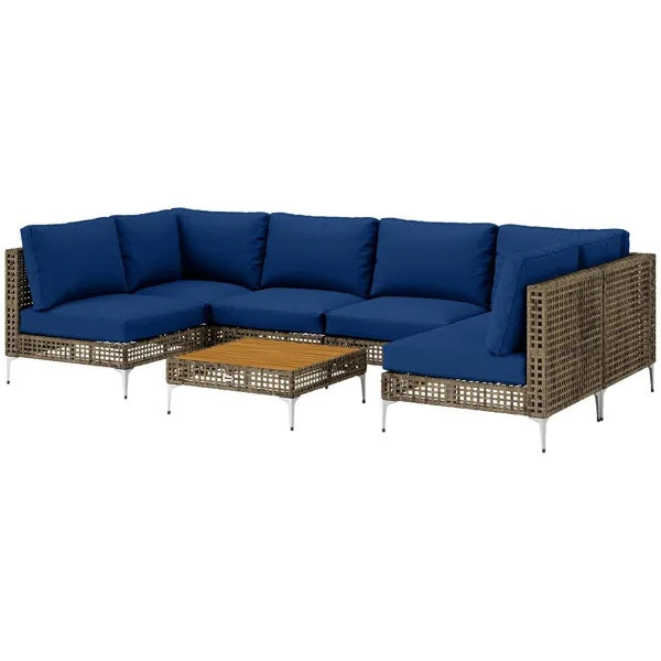 Patio furniture set by AdTec: woven rattan outdoor sectional with blue cushions and matching coffee table.