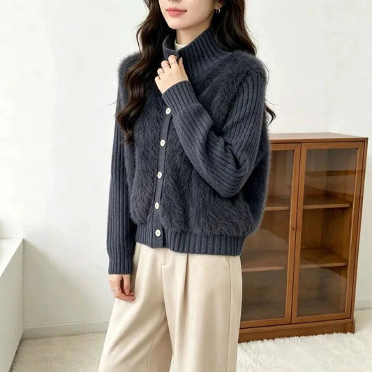 Sweater by eprolo; navy knit with stand-up collar, single-breasted front, and faux fur panels.
