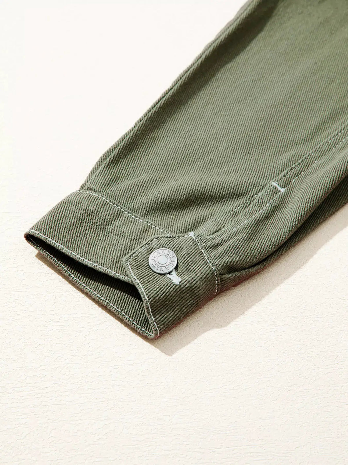 Boyfriend denim jacket sleeve cuff in olive green with metal button closure