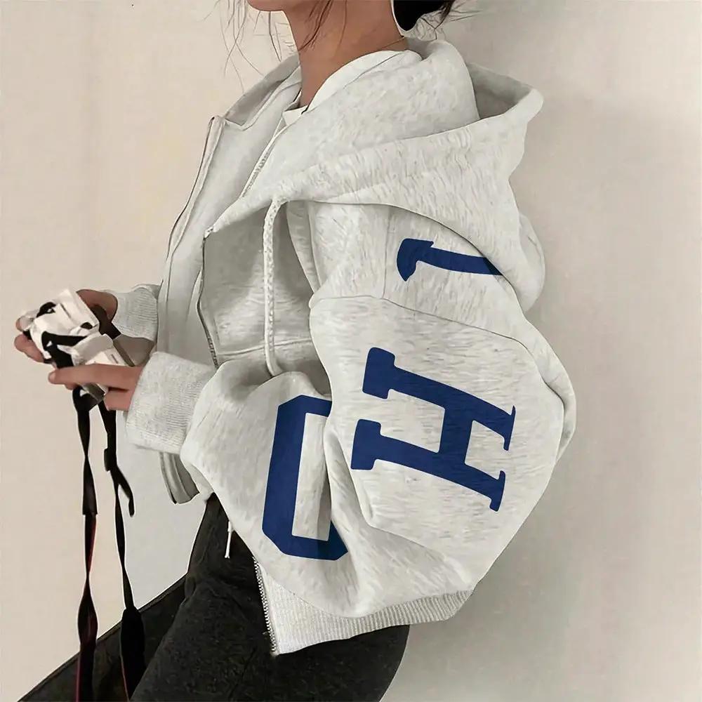Soft full-zip long sleeve sweatshirt in light gray with oversized fit and bold blue graphic on the sleeve.