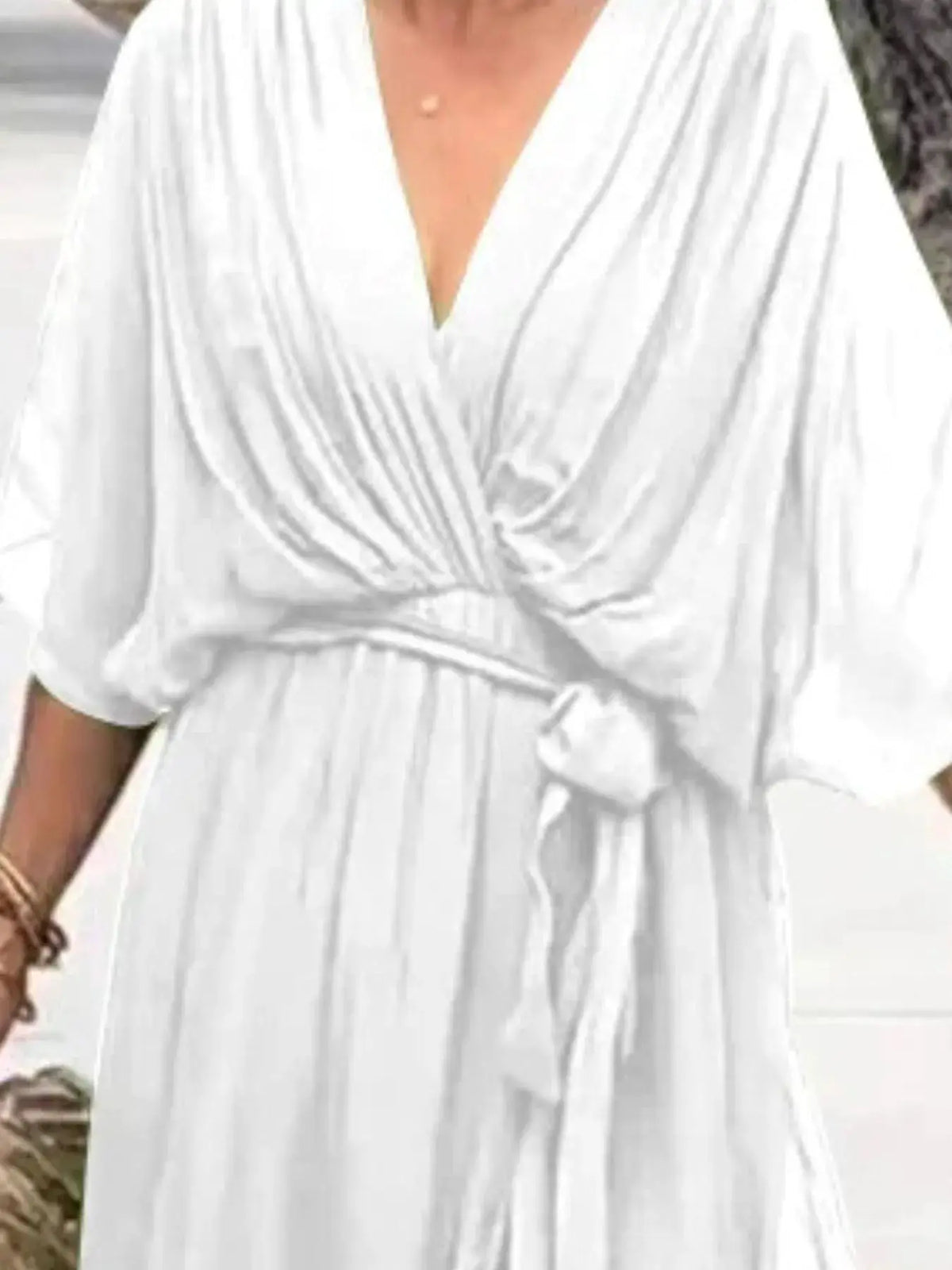 Plus-size white flowy tie-front midi dress with flutter sleeves and waist belt