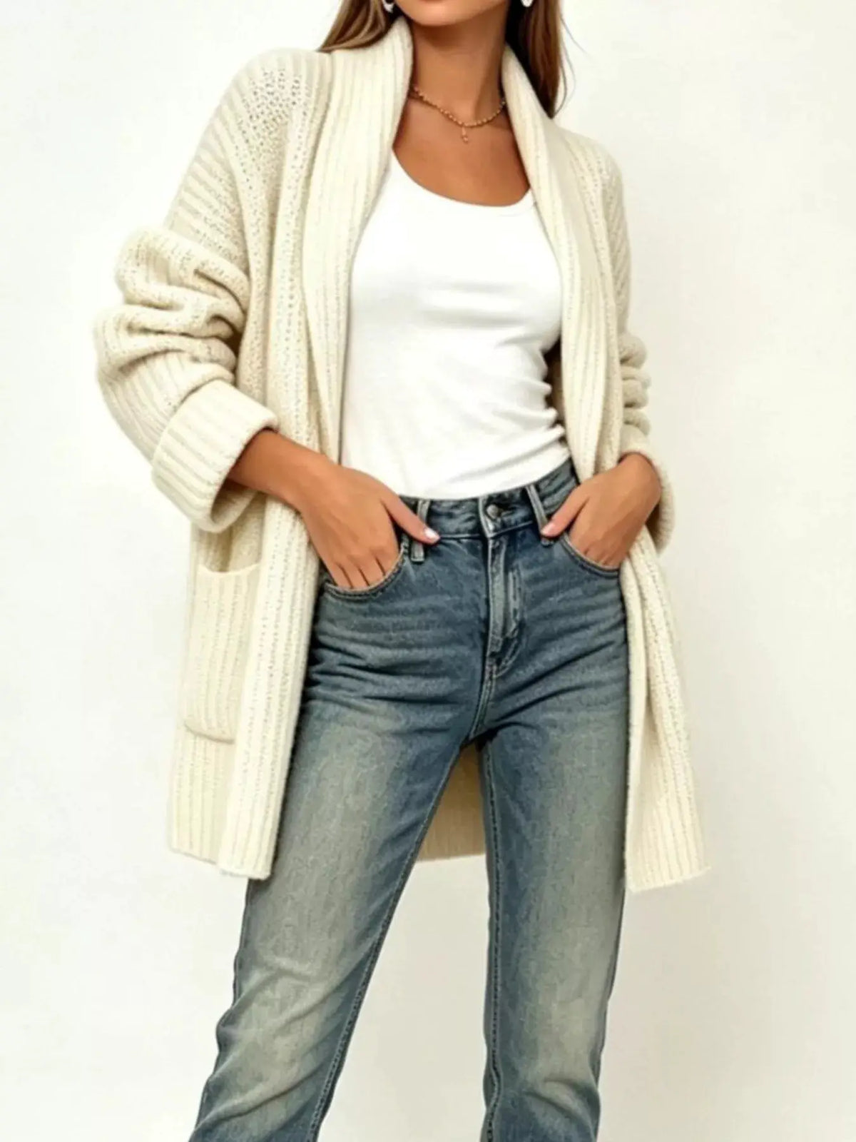 Plus size ribbed open-front cardigan with side pockets in cream, worn over white tee and jeans.