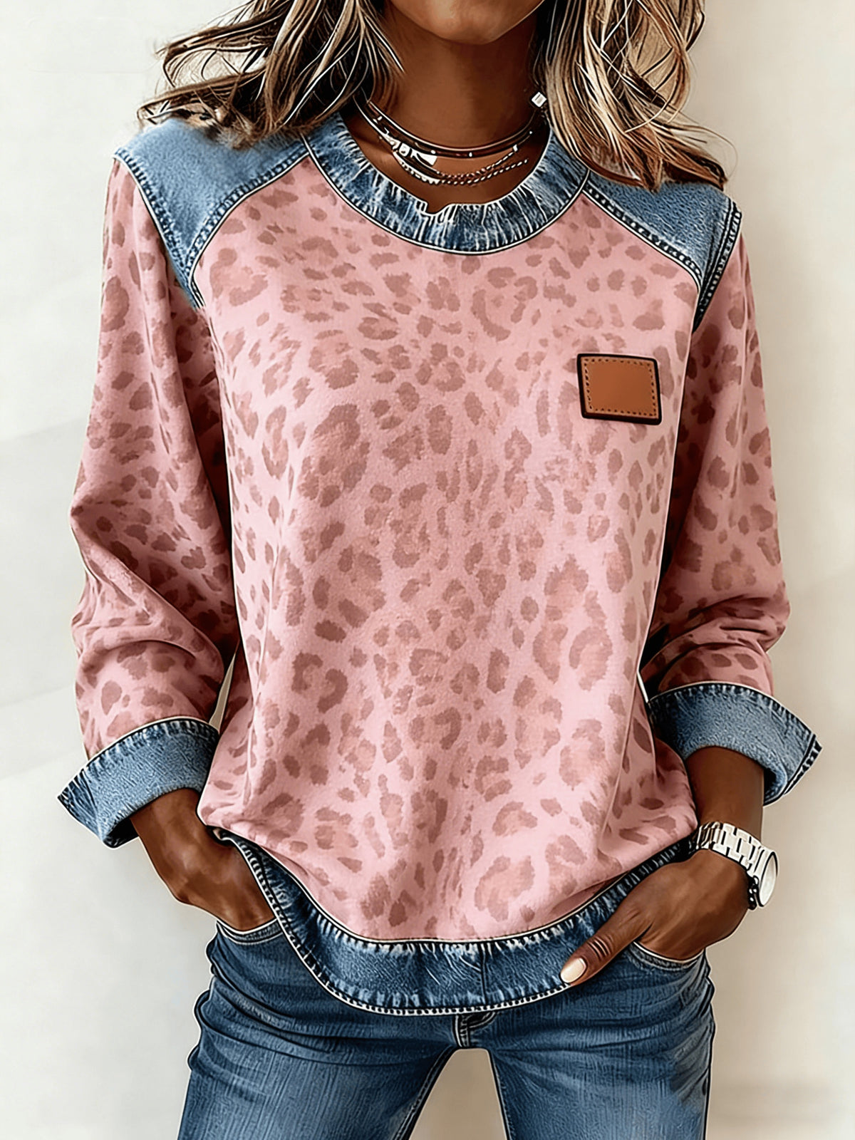Women's patchwork denim sweatshirt in pink leopard print with a blue denim yoke