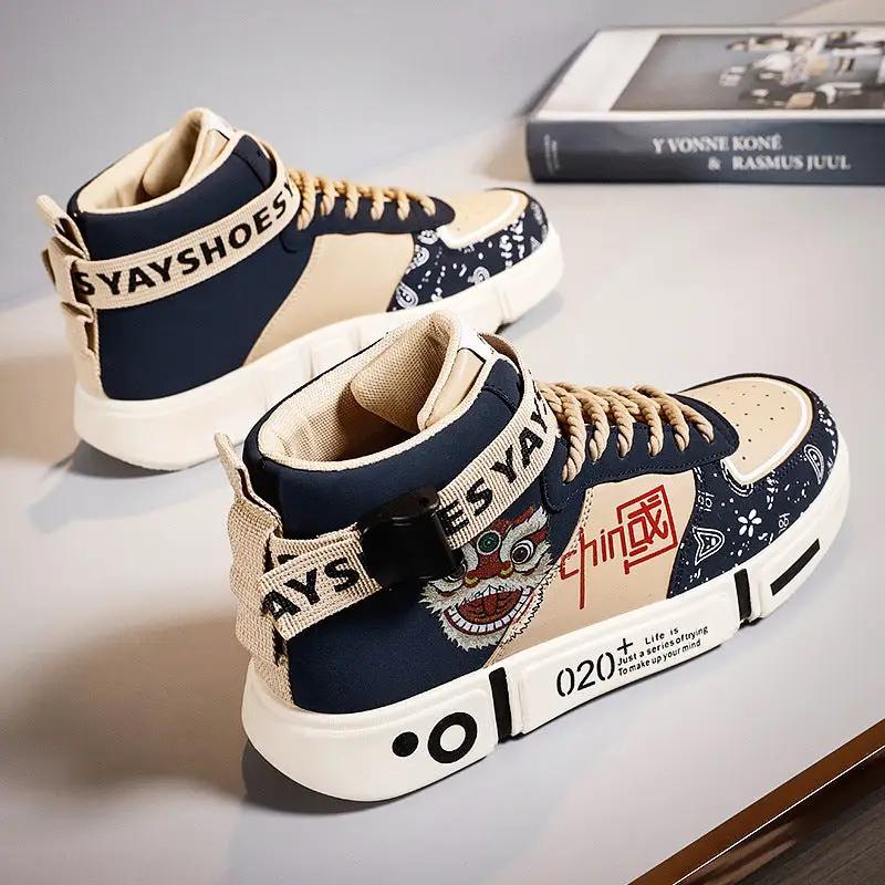 Sneakers by eprolo, two-tone navy and beige board shoes with a white sole and strap detailing.