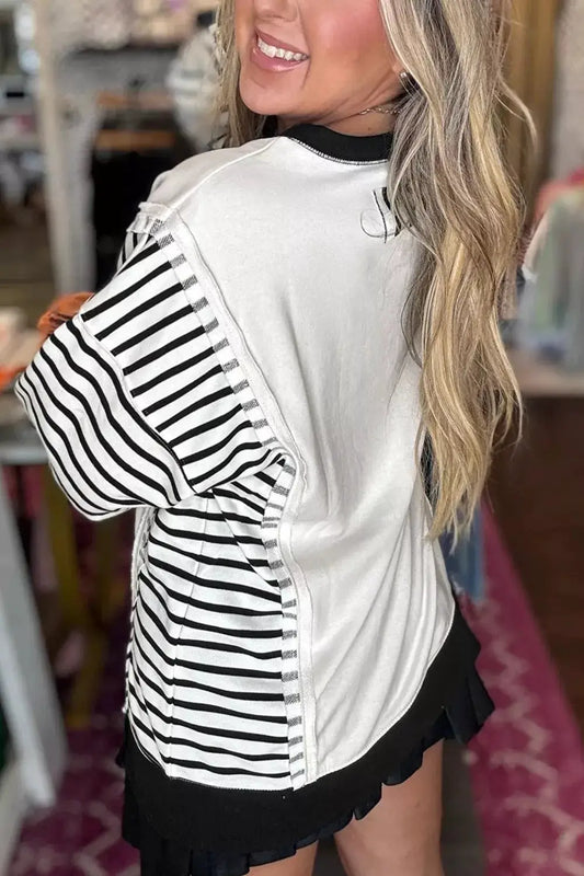 Color Block Striped Cotton Blend Long Sleeve Sweatshirt by Trendsi with white body and black striped sleeves.