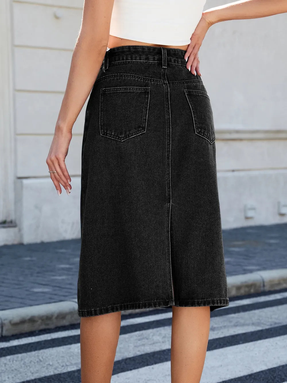 Slit-back denim midi skirt, black with back pockets and belt loops.