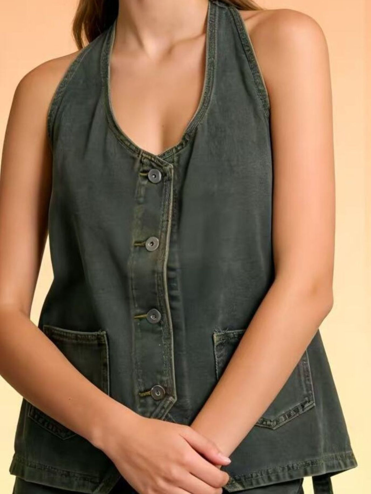 Halter-neck denim vest in dark wash with button-front closure and front pockets