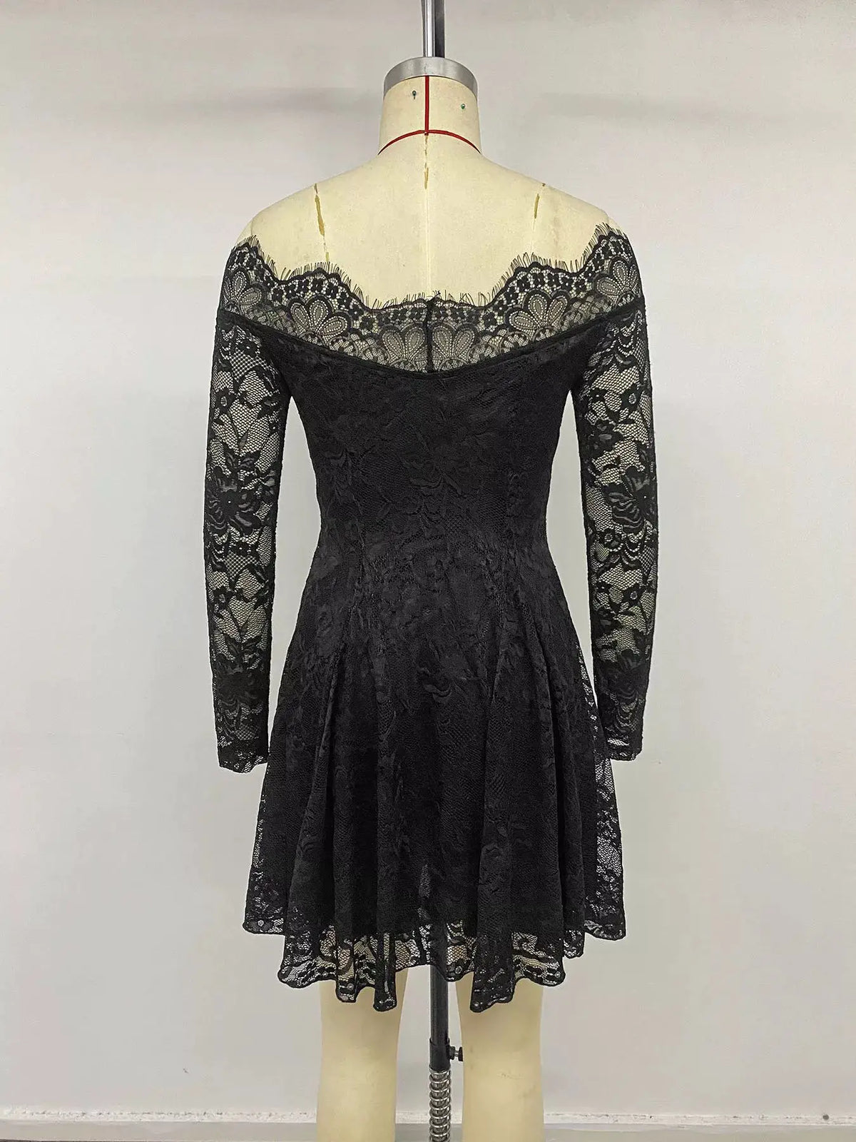 Lace Off-Shoulder Mini Dress in black with long sleeves on a mannequin
