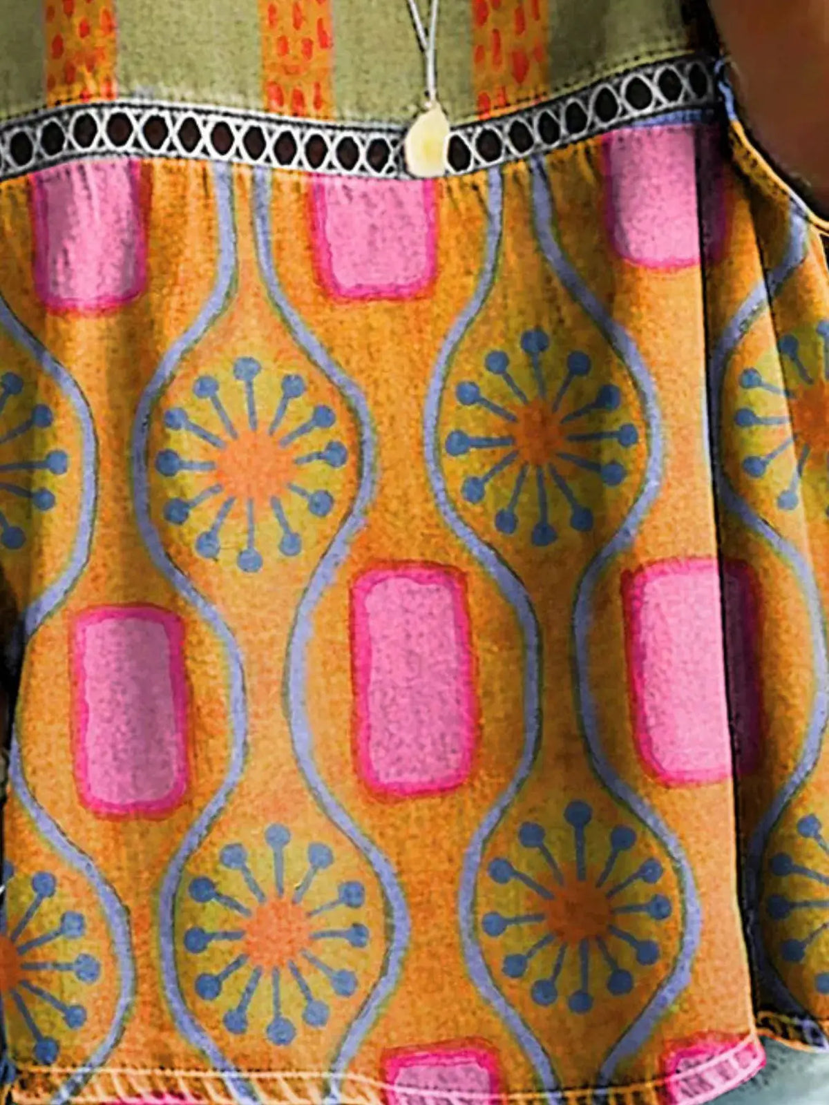 Full Size Hollow-Out Round-Neck Top in vibrant orange with pink and blue geometric pattern