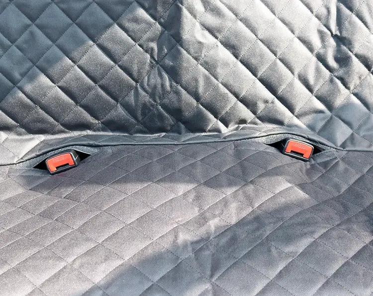 Dog car seat cover quilted in black with red buckle fasteners on rear seat protector