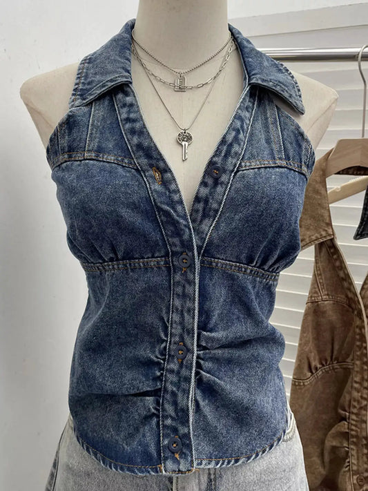 Premium textured smocked denim halter top in blue with front button closures.
