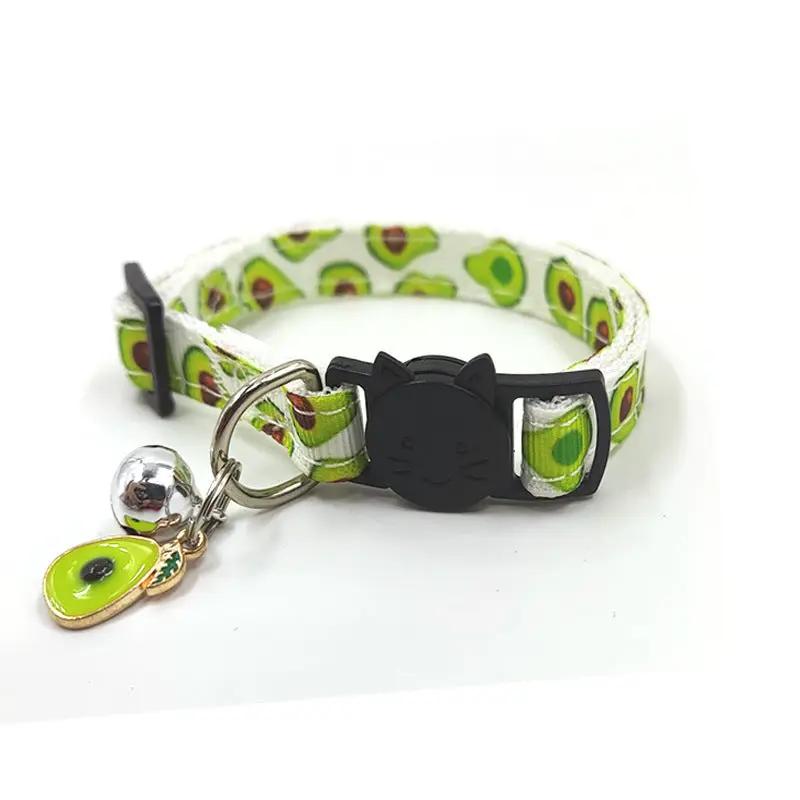 Cat collar with avocado-print strap, black cat-face buckle, silver bell, and avocado charm