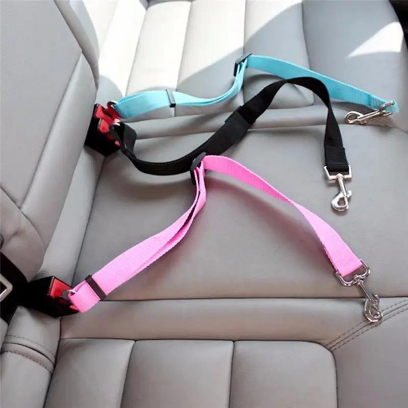 AdTec adjustable pet car seat belt set with pink, teal and black straps and metal clips.