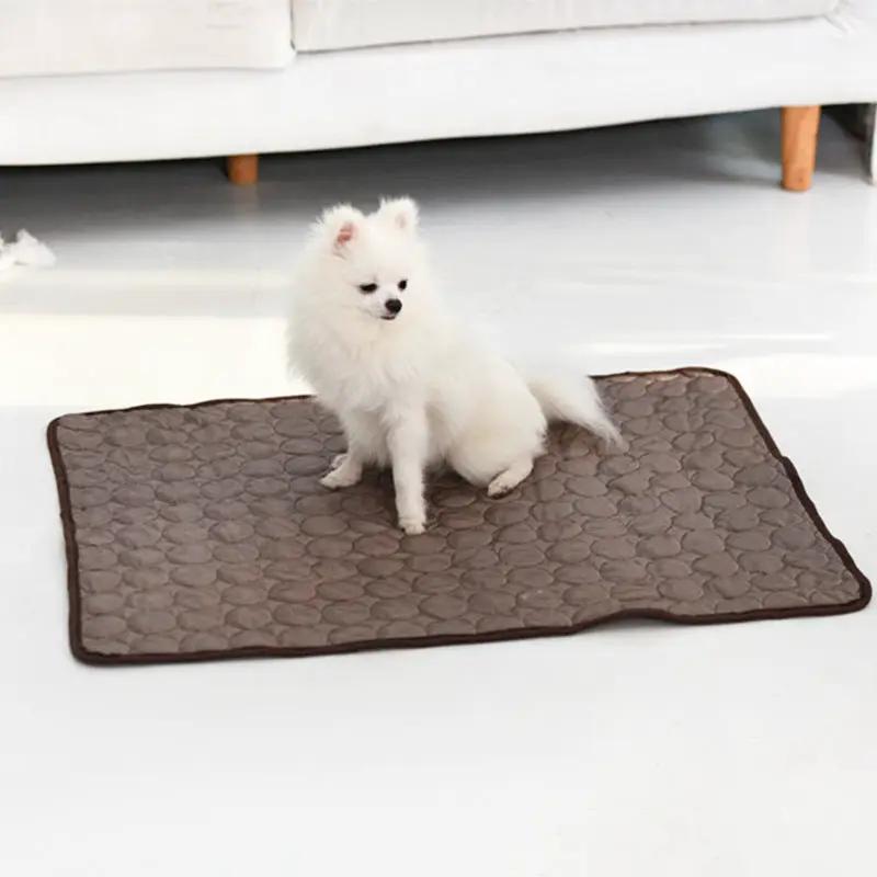 Summer Cooling Pet Sleeping Ice Silk Mat by AdTec, brown quilted mat on white floor with a white fluffy dog.