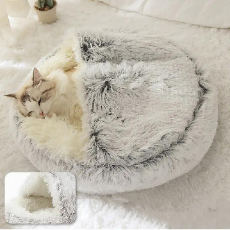 Plush shell pet nest, round gray faux-fur bed with cream interior.