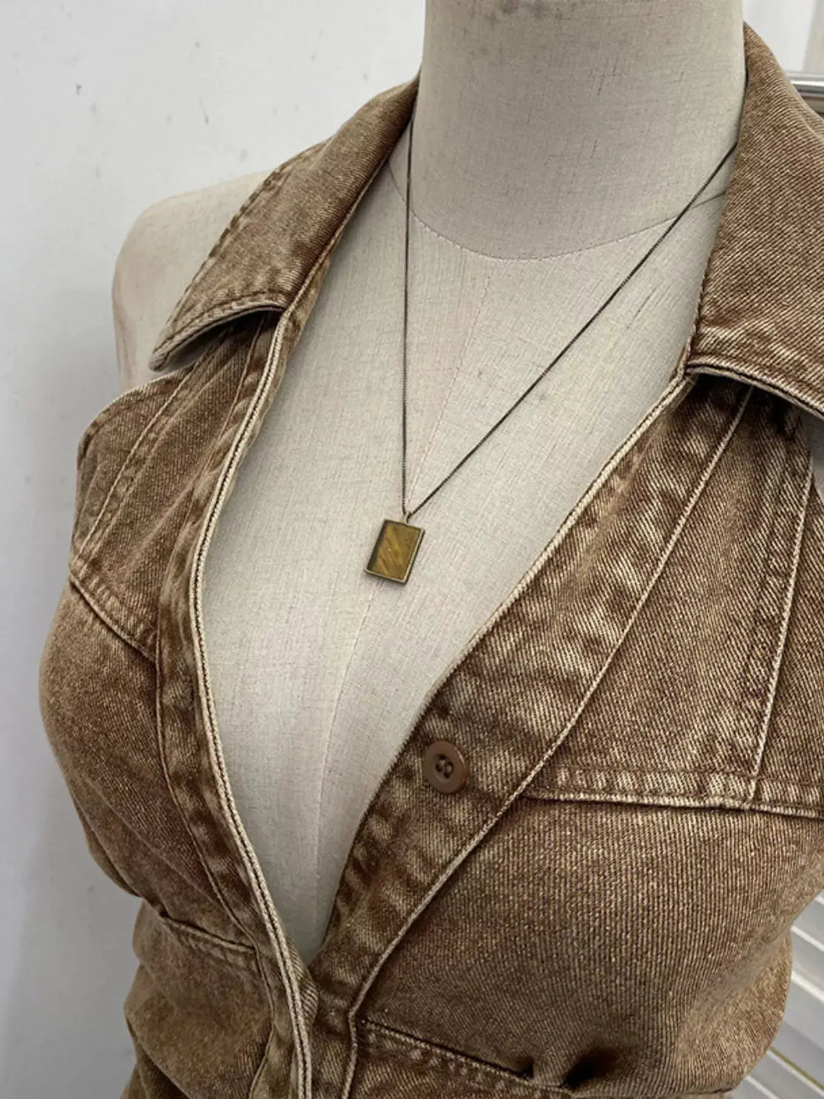 Premium textured smocked denim halter top on mannequin; brown denim fabric