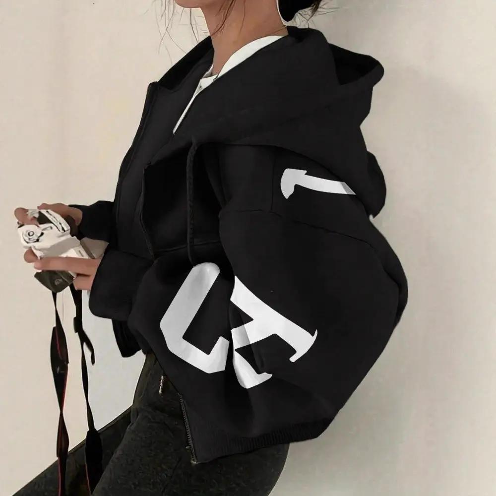 Soft full-zip black hoodie sweatshirt with oversized fit and white graphic lettering on the sleeve.
