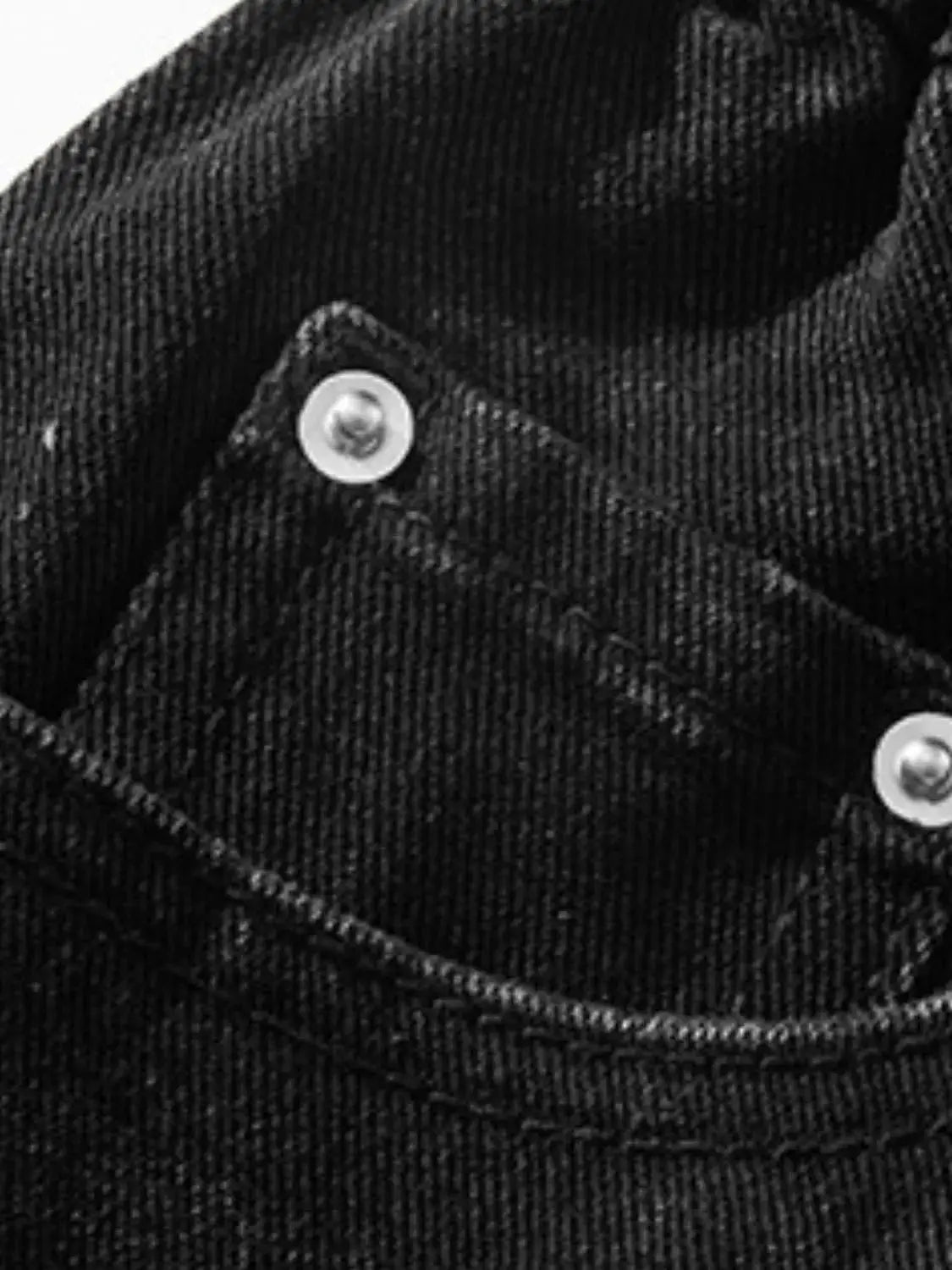 Men's plus-size stretchy black denim shorts fabric close-up with metal buttons and front pocket