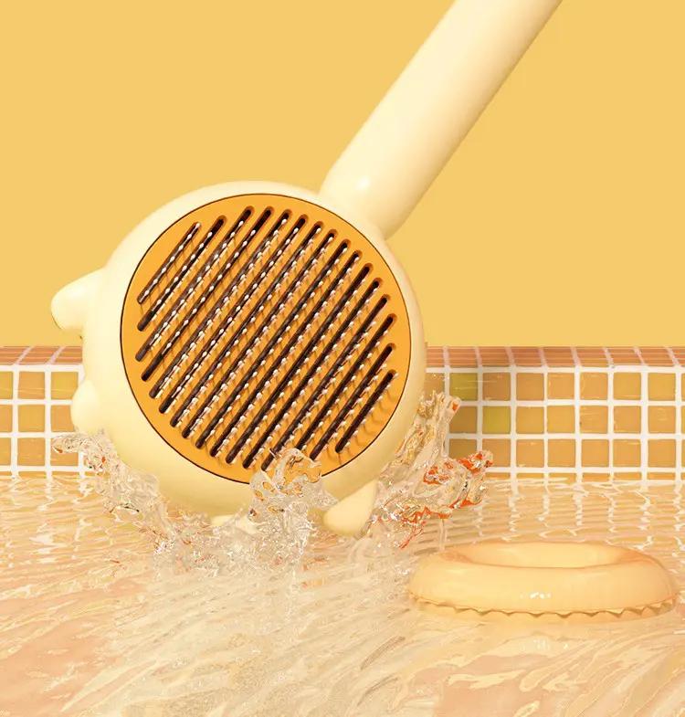 Cat massage grooming comb with yellow round head and black bristles