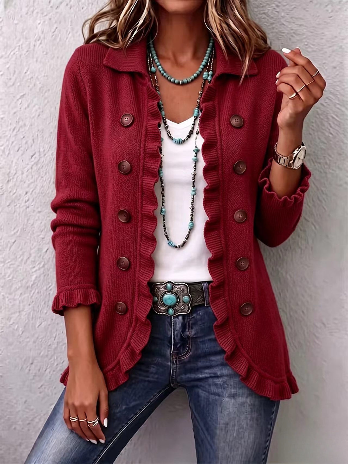 Long red knit cardigan with ruffled edges and large buttons, styled with turquoise jewelry.