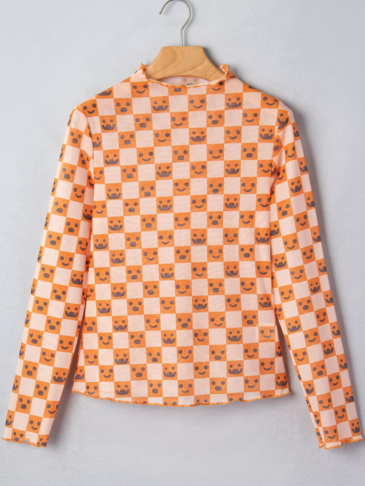Abstract Halloween Pattern Long Sleeve Mock Neck Blouse in orange-peach checker with gray smiley and crown icons.