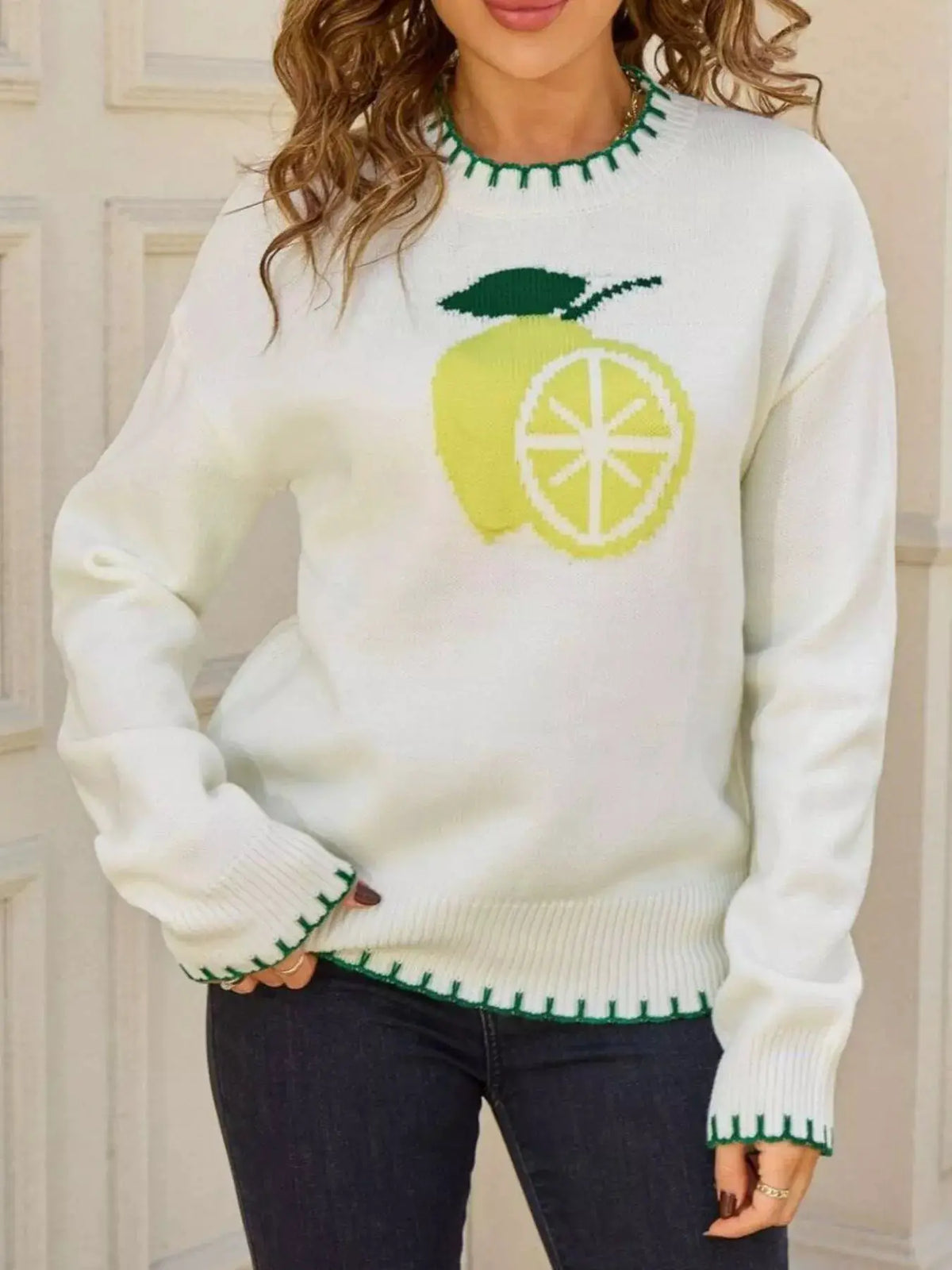 Sweater with lemon-graphic knit design by Trendsi; white round-neck pullover with green trim.