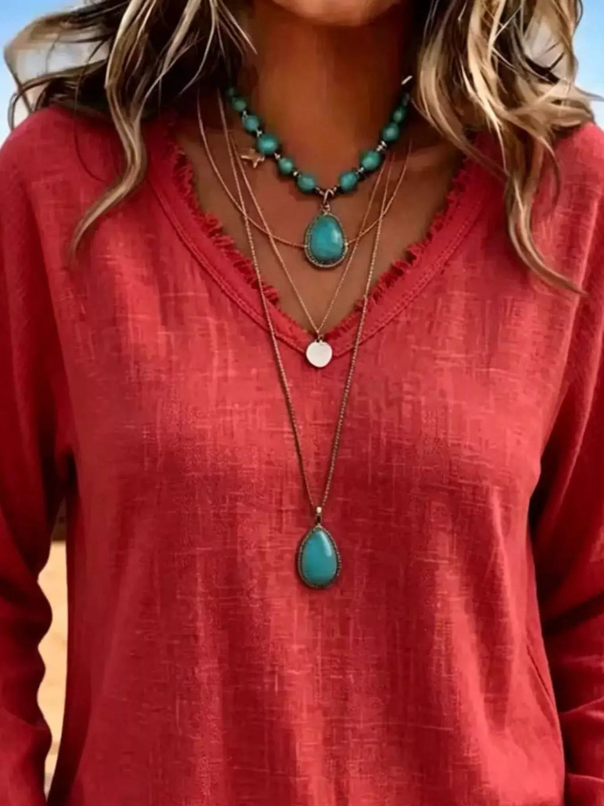 V-Neck Frayed Hem Long Sleeve T-Shirt in red with layered turquoise beaded necklaces