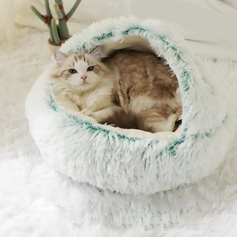 Plush shell pet nest in white fur with turquoise trim by AdTec, with a cat inside.