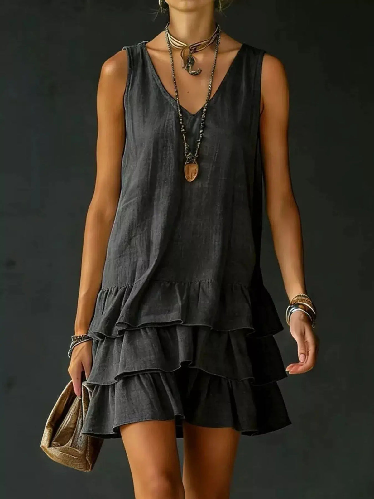 Plus-size sleeveless V-neck dress with a tiered, ruffled hem in charcoal black