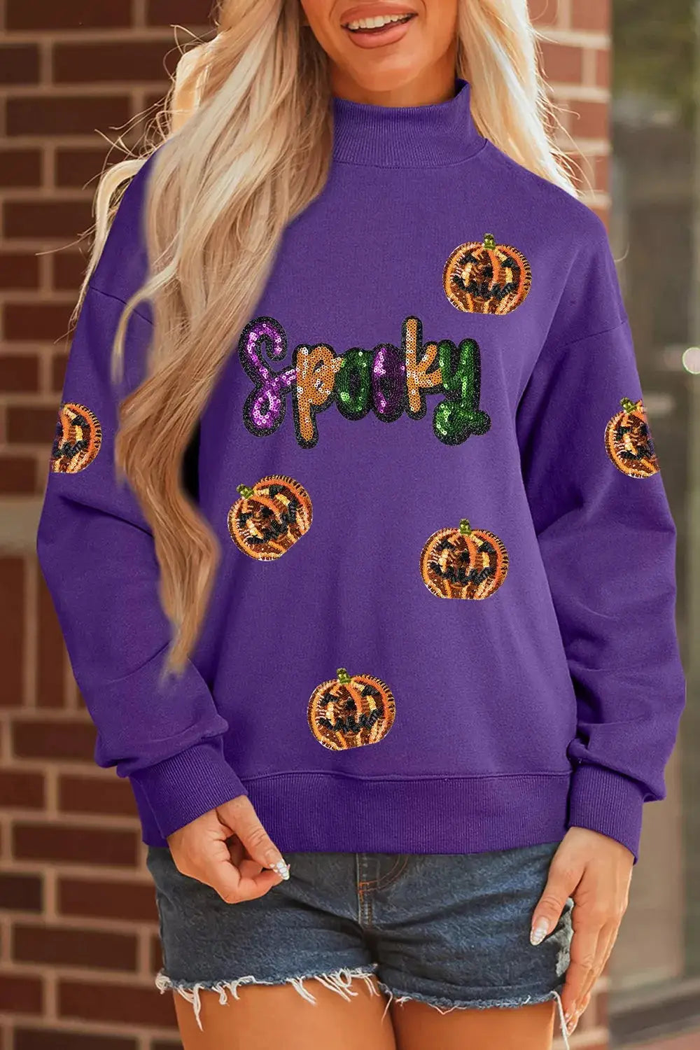Sequin pumpkin Halloween sweatshirt in purple with glittery Spook lettering and scattered pumpkins.