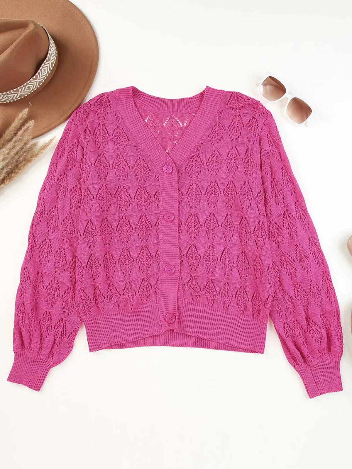 Cardigan bright pink with button-front openwork knit and textured pattern; ribbed hem and cuffs.