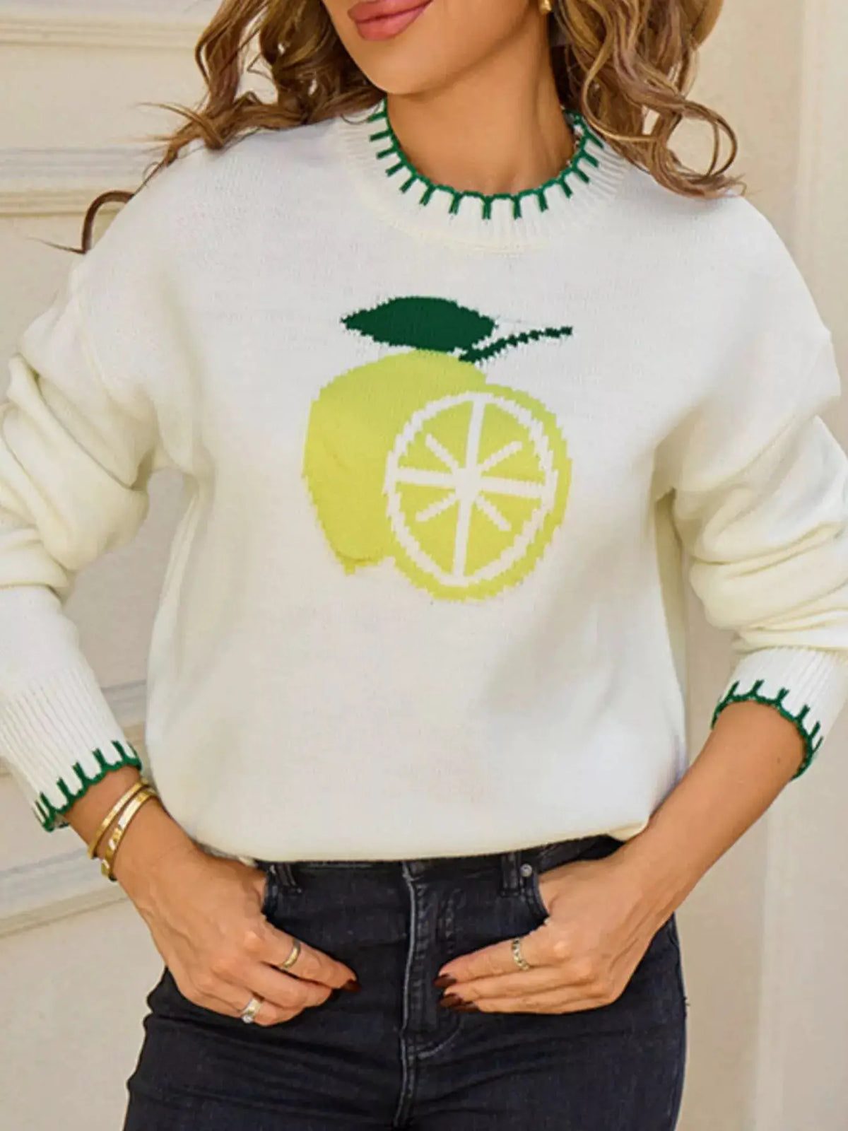 Warm lemon round-neck sweater in white knit with a yellow lemon graphic and green trim at neckline and cuffs
