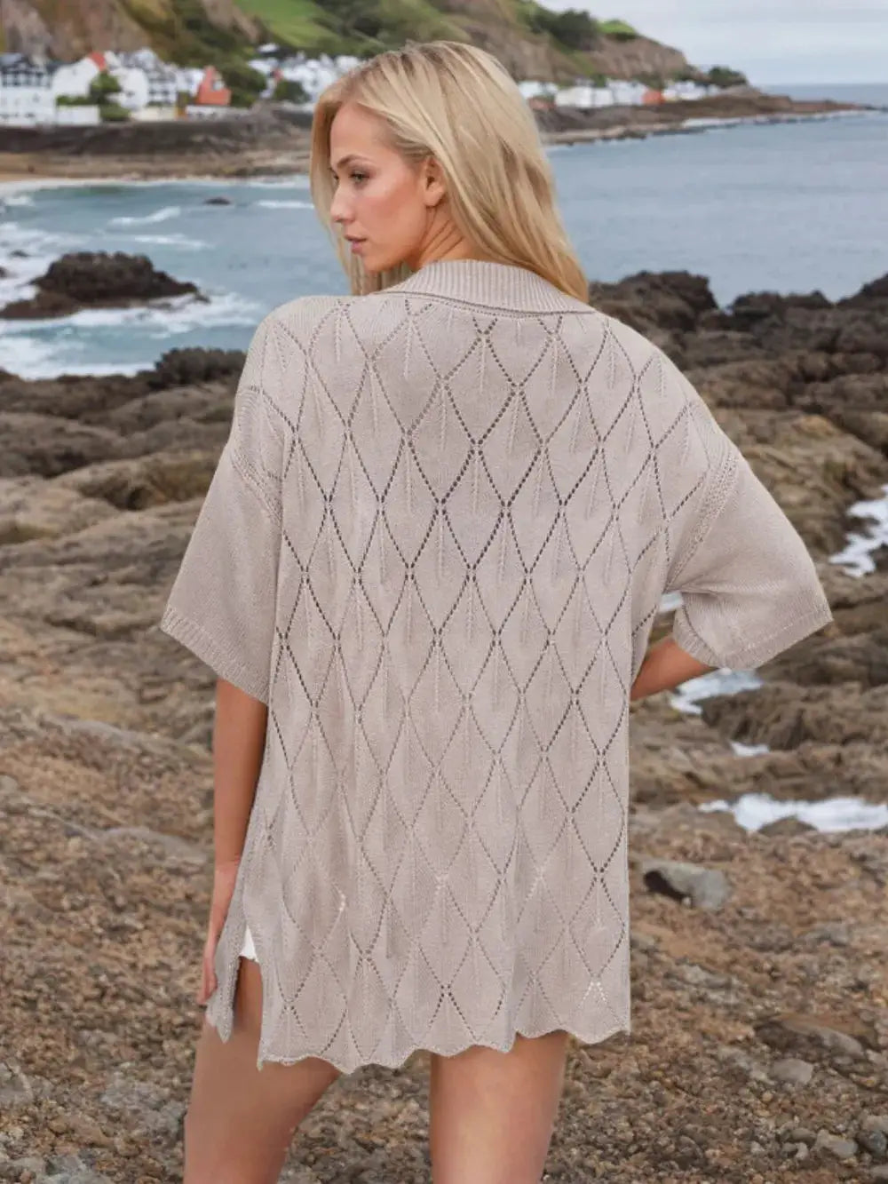 Womens beige eyelet knit shirt with collared neck and button-down front, short sleeves.