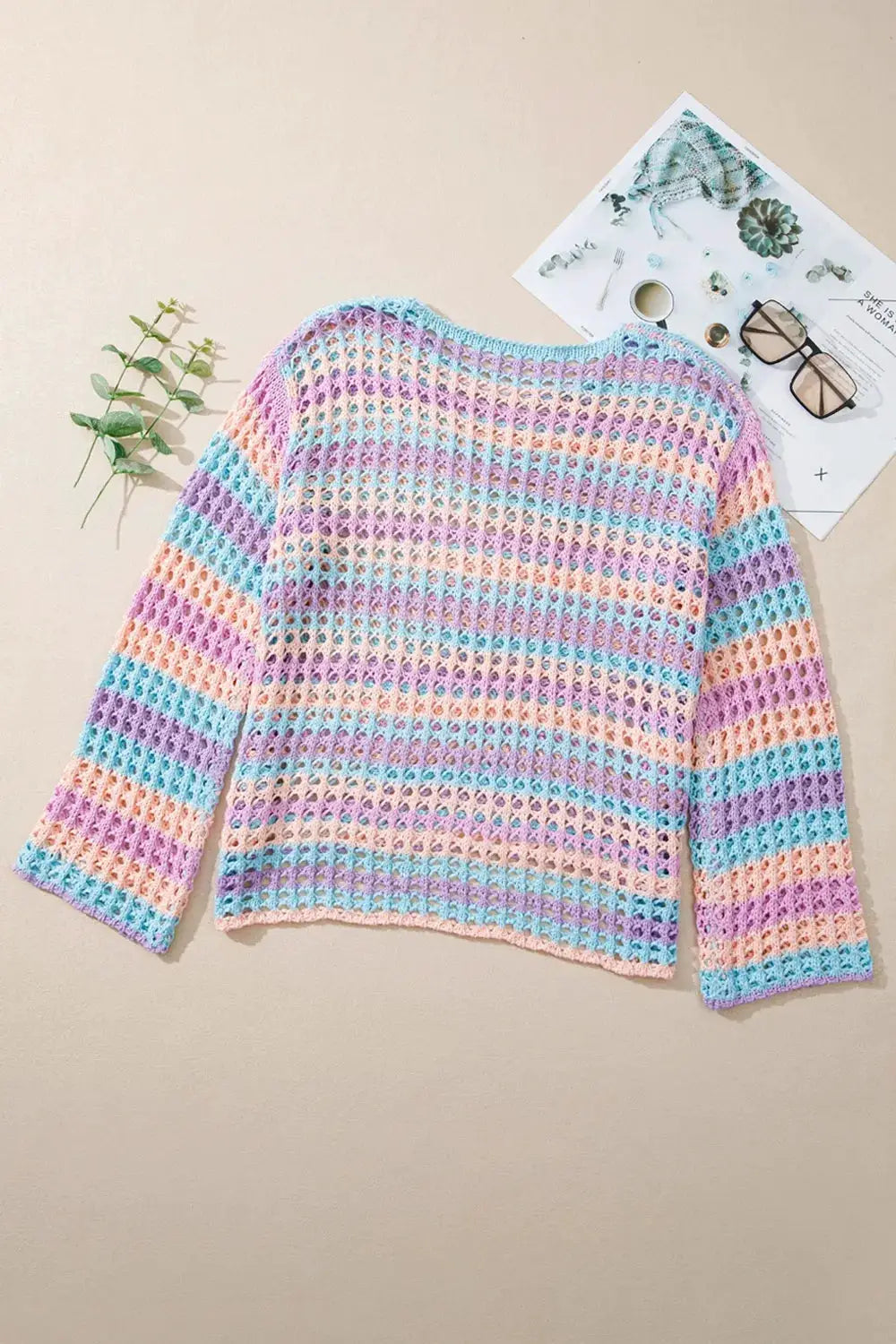Striped openwork knit cover-up with round neck and side slits in pastel peach, lavender, blue.