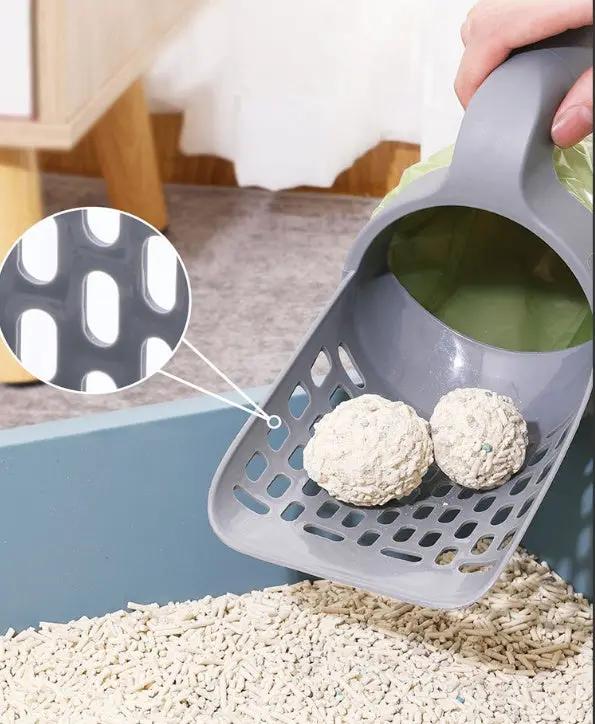 Gray plastic cat litter scoop with integrated basket and large-capacity toilet bucket, showing two litter balls inside