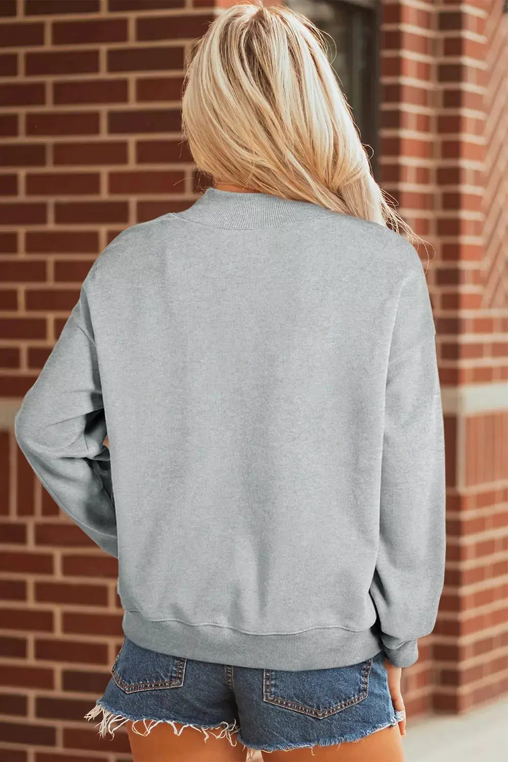 Gray baggy mock-neck sweatshirt, back view with ribbed hem and cuffs