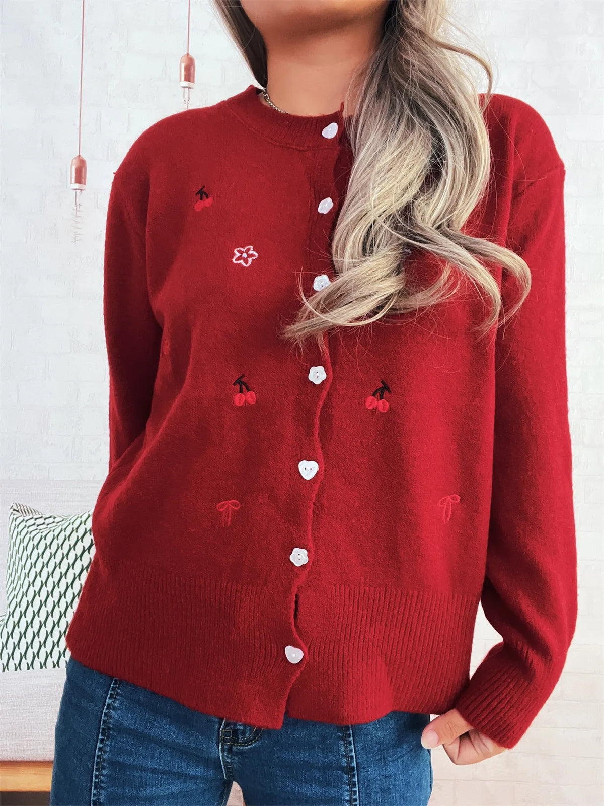 Red ribbed knit cardigan with button front, white heart-shaped buttons and cherry embroidery accents