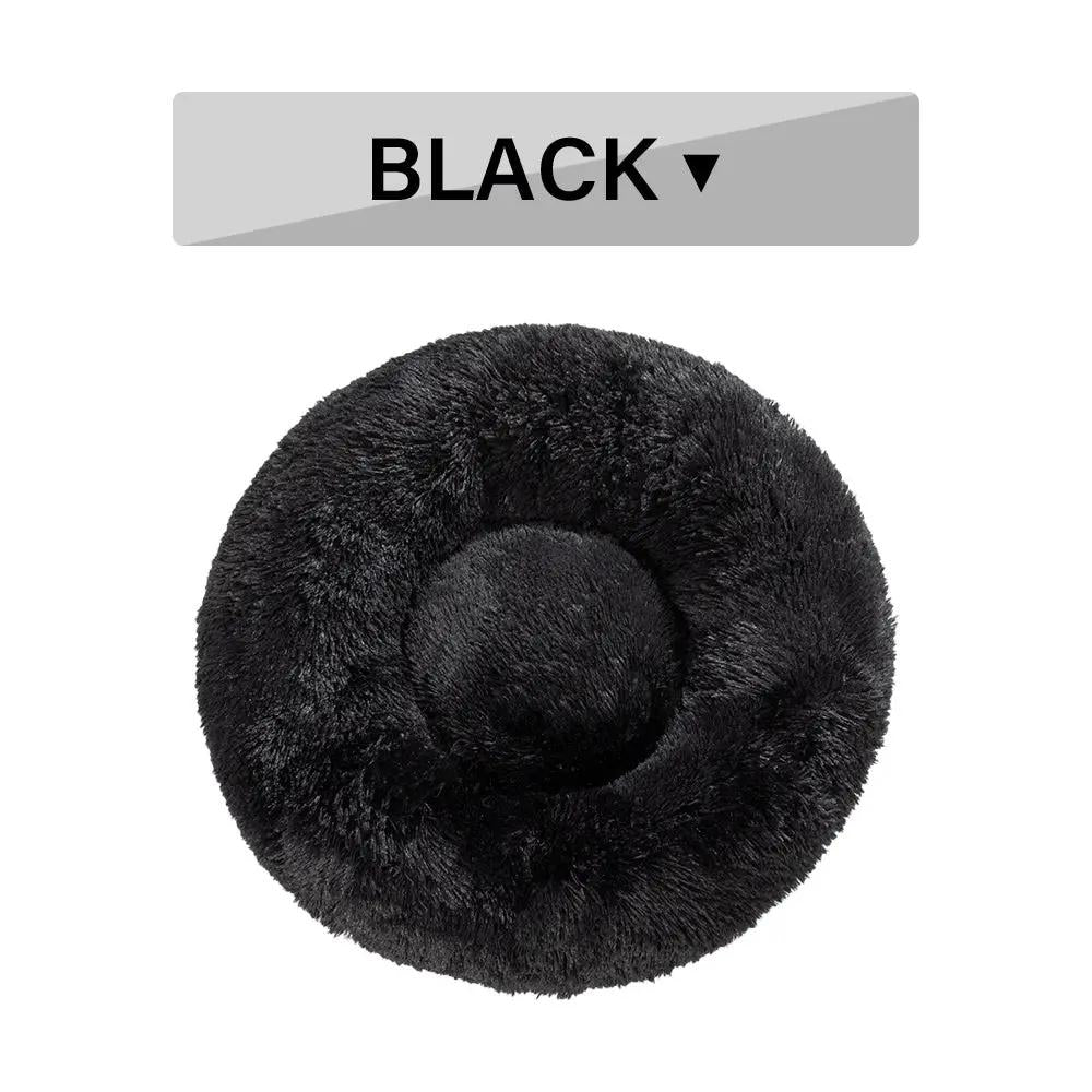 Fluffy black donut dog bed in plush material with round, cozy cushion.