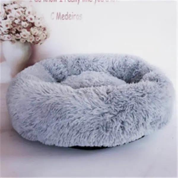 Round long-haired cat nest pad in soft gray plush, cozy autumn and winter bed.