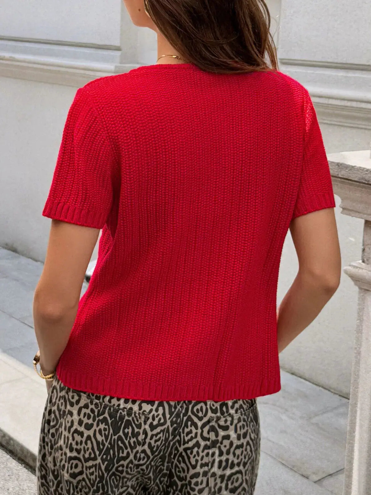 Button Down Short Sleeve Cardigan in red knit, soft acrylic blend; back view on model.