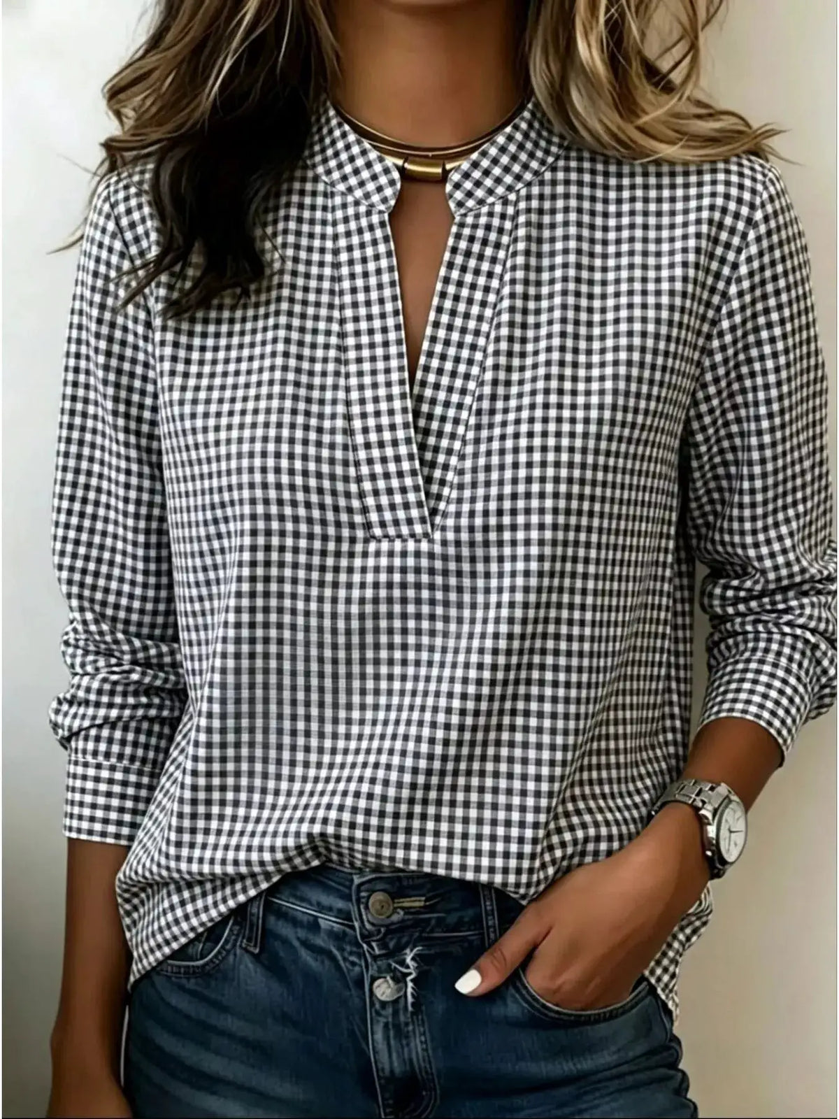 Plus-size plaid notched long-sleeve blouse in black-and-white gingham, styled with denim jeans