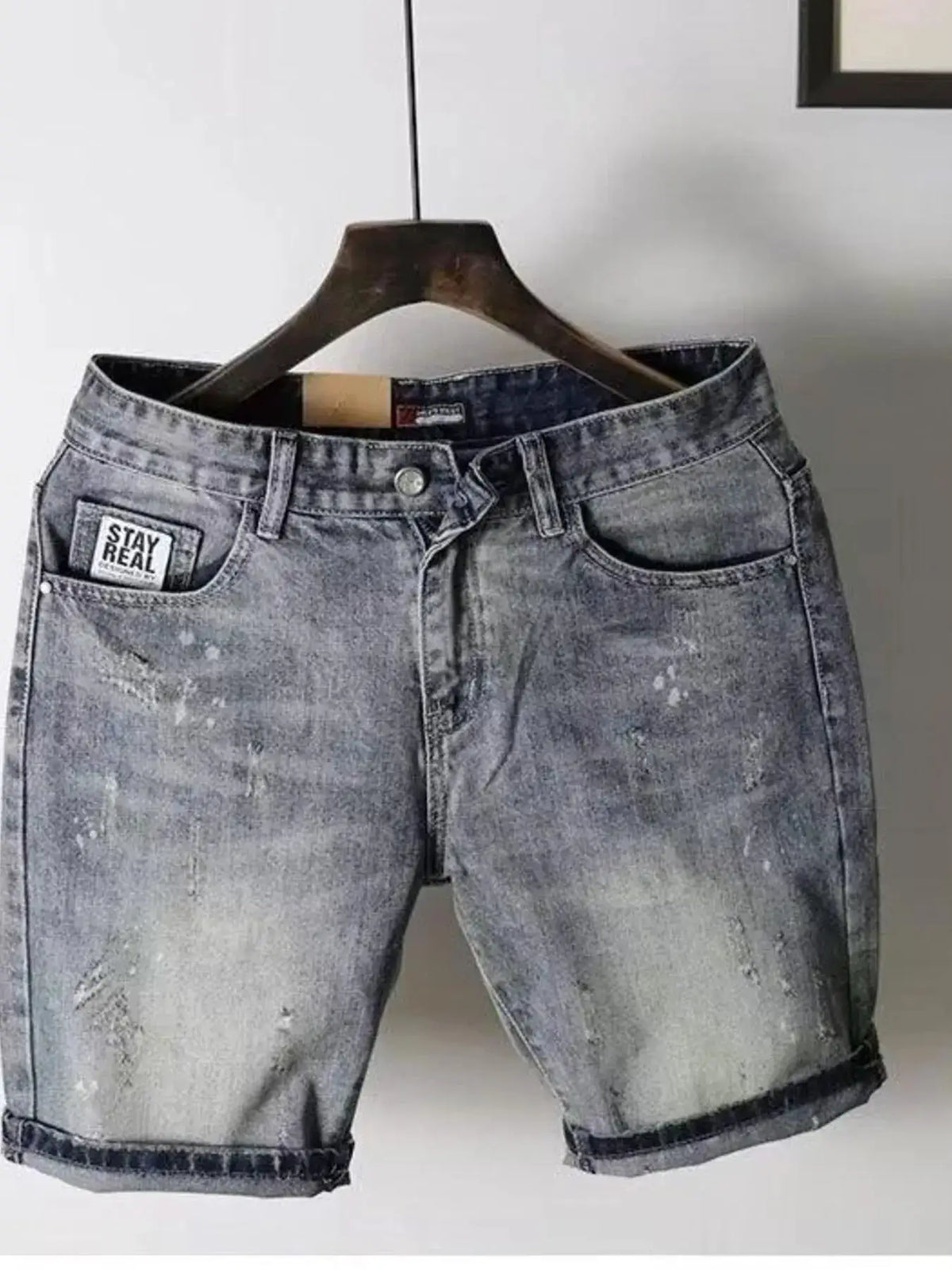 Mens lightweight stretch denim shorts, grey washed for summer, with front pockets and rolled cuffs.