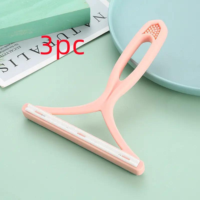 Silicone double-sided pet hair remover in pink with white lint strip for clothes and carpets