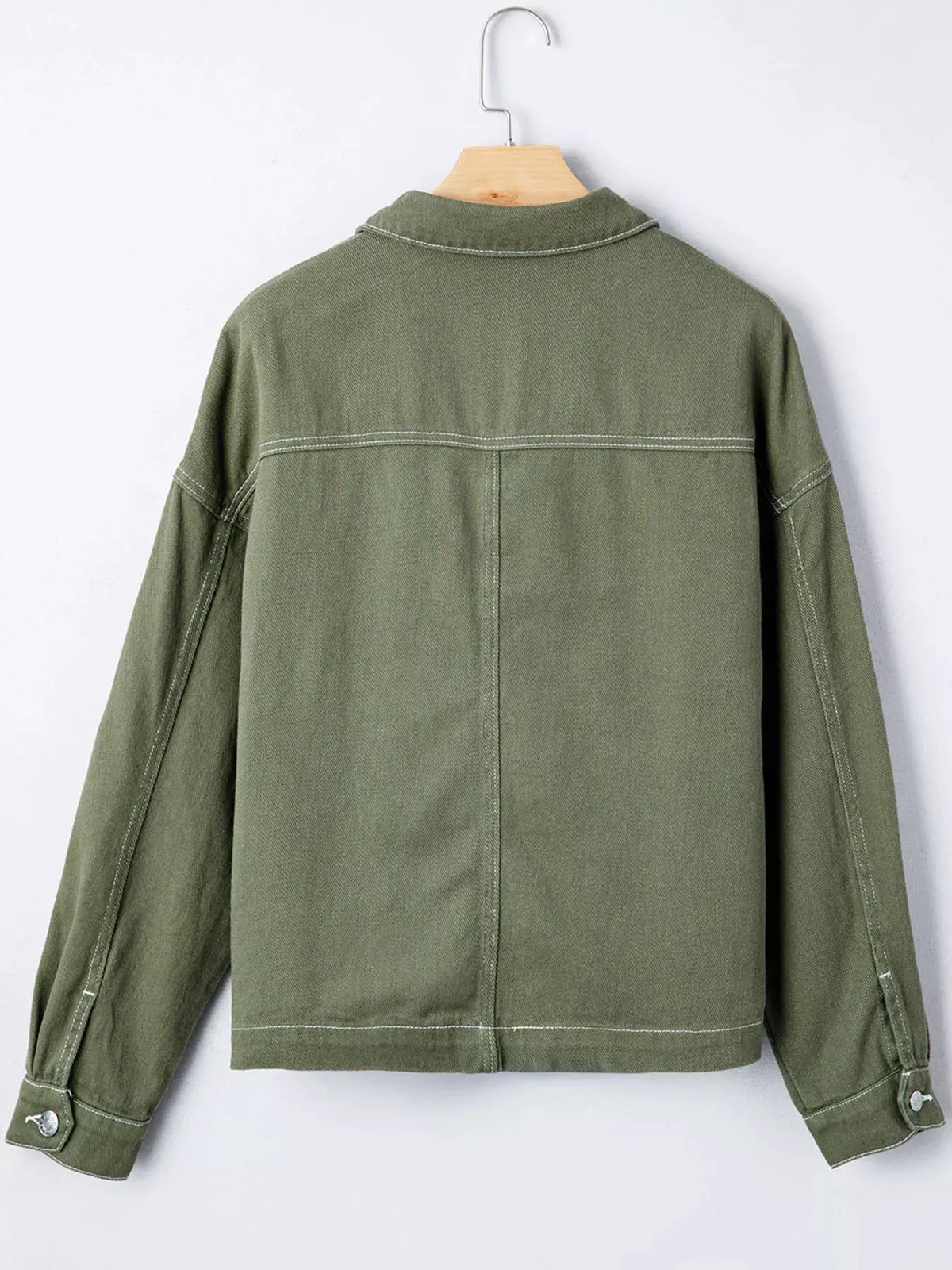 Boyfriend denim jacket in olive green with white contrast stitching, back view showing yoke seam and buttoned cuffs.